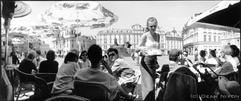 2000.06 Prague. Outdoor Cafe_hf <div align=left>June 2000<br>Dear PMers, <br>Sometimes, here in former East Germany, I wonder what I am doing...or, what should I be doing? Confronted daily by evidence of recent history, and recalling the words of Cartier-Bresson, "The world is in chaos, and you are photographing rocks!" (he was criticising Ansel Adams and Edward Weston apparently), and so...soap-box time... <br>MEDIA and the TRUTH??? once again wracked by doubts about our erstwhile press-people...and wondering if you are aware of a 2 hour documentary, "New World Order (Somewhere in Africa)", by Phillipe Diaz, recently premiered at Cannes: what is really going on in Sierra Leone!!! He stunned the audience with scenes of UN troops (our defenders of human rights) tacitly approving of the murder of civilians...etc. After the screening, the director faced a barrage of questions including: "How can this be? The UN - how could they? Why have the journalists not told us of this?"...a reasonable question...I wonder what the answer is! Someone once said "History repeats". Well, it seems it has to, because no-one listens!" Hmmm...boiling blood and itchy feet bothering me again!<br>Dean<br>