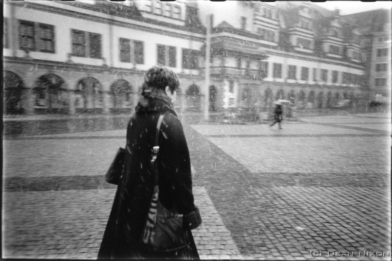 2002.02 Marktplatz, Leipzig. Winter_hf <div  align=left>Feb 2002<br>Hi Folks,<br>2002 started with more than the usual fireworks (it looks & sounds like a war here every New Years Eve)...the winter snows caused plenty of problems, and the arrival of the Euro (pronounced "oiro") has generated lots of chaos both real and imaginary. For the financial types its about the US dollars power, while Josef Average ponders the loss of cultural identity.<br>But now, a few weeks into the year, the weather has suddenly switched into Spring mode (minis and midriffs need so little encouragement here!) and euros are swapped for beers without so much as a nostalgic twinge anymore.<br>Shopping hint for photographers travelling to Europe: Prague, and not just the view (photo ops galore)...there are a couple of shops there packed with everything photographic ever invented   and still remarkably cheap.<br>Ok, space problems and the never ending search for decent coffee prevent me from ranting about the great shows that abound, interesting photographers Ive met and so on...maybe next time.<br>Bis dann,<br>Dean<br>